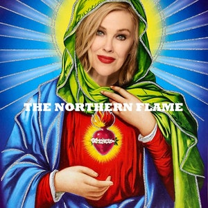 May include: A digital art print of a woman with blonde hair wearing a green and blue robe. The woman is holding a red heart with flames on top. The text "THE NORTHERN FLAME" appears twice on the image.