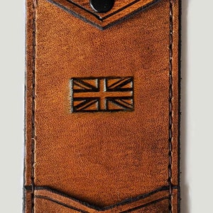 May include: A brown leather wallet with a flap closure and a Union Jack design. The wallet has a snap closure and the initials "E.G." embossed on the front.