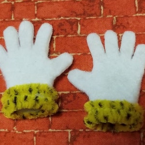 May include: A pair of white felt gloves with yellow and black fuzzy cuffs.