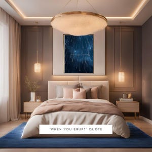 May include: A bedroom interior featuring a large bed, a blue rug, and a framed print with a quote about erupting. The print has a dark blue background with white stars and a quote in white text. The bedroom has a modern design with a gold chandelier and bedside tables.
