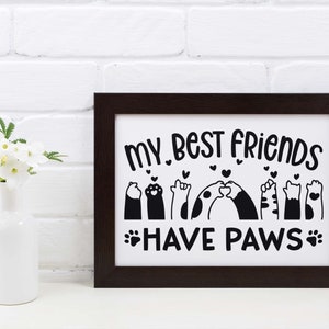 May include: Black and white framed print with the text "My best friends have paws" and a graphic of paw prints and animals with hearts.