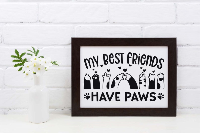 May include: Black and white framed print with the text "My best friends have paws" and a graphic of paw prints and animals with hearts.