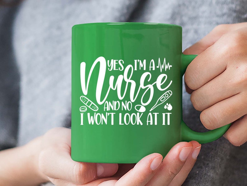May include: Green ceramic mug with a white design that says "Yes I'm a Nurse and no I won't look at it". The design also includes a heart rate line, a bandage, a pill, a thermometer, and two drops of blood.