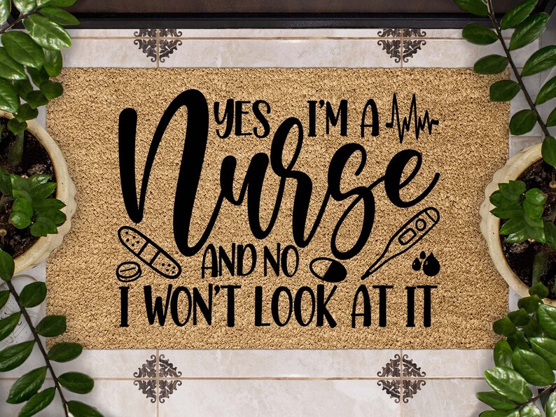 May include: A brown coir doormat with the text "Yes I'm a Nurse and no I won't look at it" in black cursive font. The text is surrounded by medical symbols including a heart rate monitor, bandages, pills, a thermometer, and blood drops.