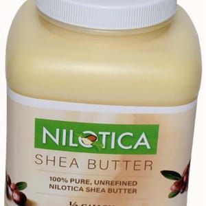 May include: A large, off-white plastic jar with a white lid. The label reads "NILOTICA SHEA BUTTER" and "100% PURE, UNREFINED NILOTICA SHEA BUTTER". The jar contains a light yellow substance, and is labeled as 1/2 gallon (64 fl oz).