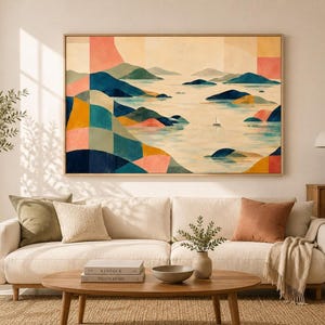 May include: A rectangular wall art print featuring a stylized landscape with geometric color blocks in shades of blue, green, yellow, and coral. The scene depicts rolling hills and islands surrounded by water, with a small sailboat in the center.