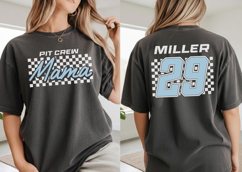 A woman wearing a gray t-shirt with a checkered pattern and the text "PIT CREW Mama" printed on it.