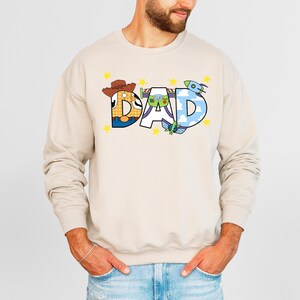 a man wearing a sweatshirt with the word dad printed on it
