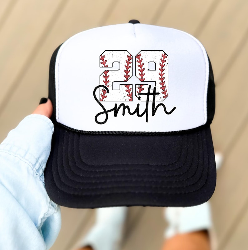 a person holding up a baseball hat with the word south on it