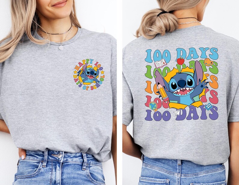 A woman wearing a gray t-shirt with a colorful graphic design featuring a cartoon character and the text "100 DAYS 100 DAYS 100 DAYS".