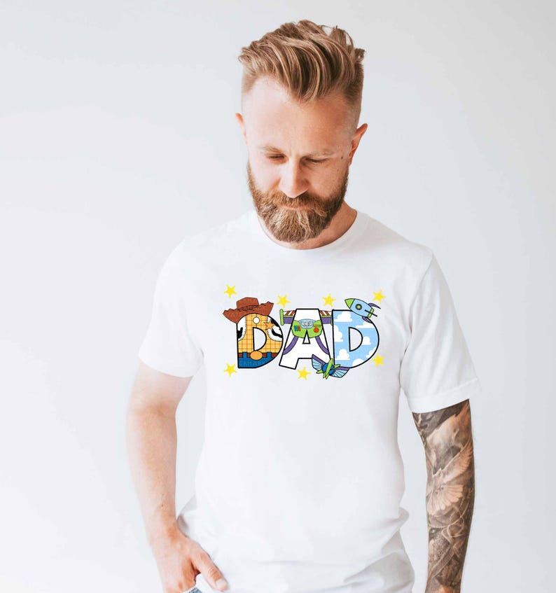 a man with a beard wearing a white shirt with the word dad printed on it