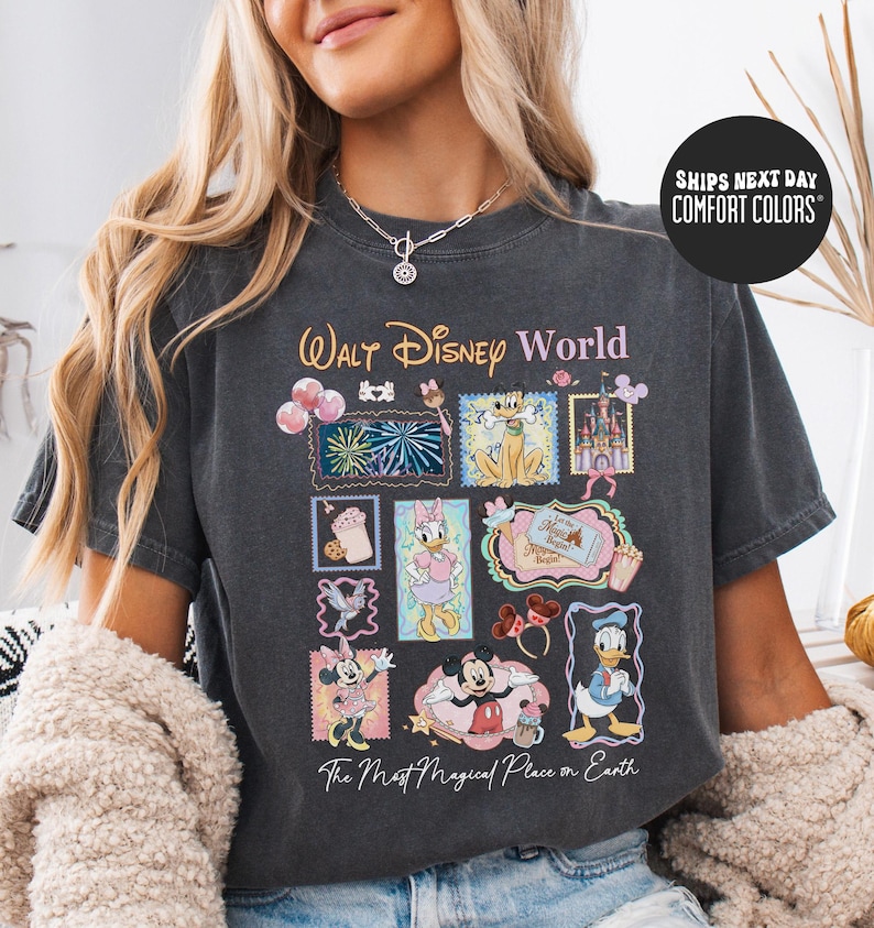 A woman wearing a black t-shirt with a Disney World-themed graphic design, including various Disney characters and elements.