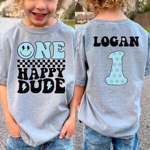 two children wearing matching shirts that say one happy dude and one happy dude