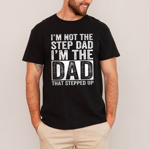 a man wearing a black t - shirt with the words i'm not the