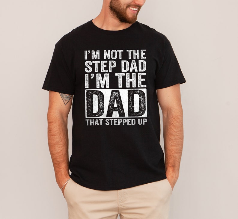 a man wearing a black t - shirt with the words i'm not the