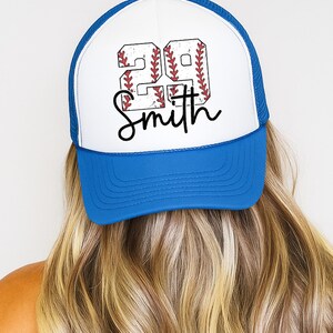 a woman with long blonde hair wearing a blue and white hat