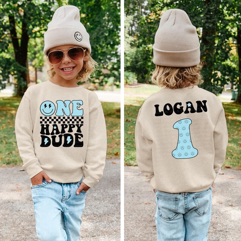 a little boy wearing a sweater that says, one little dude