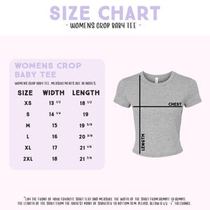 The image is a size chart for a women's crop baby tee. It provides measurements for different sizes, including XS, S, M, L, and XL, along with the corresponding width, length, and chest measurements. The chart also includes a diagram of a gray t-shirt with measurements and a label indicating the width of the shirt from the bust to the hem. The text advises to lay the shirt flat and measure the width of the shirt from the bust to the hem, and to allow a 1/2" or 1-yard length for the shirt.