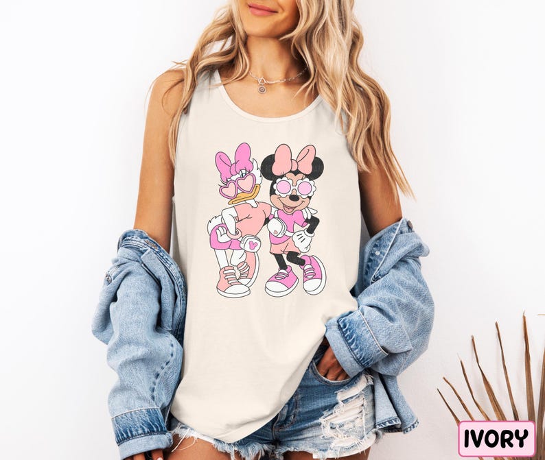 a woman wearing a mickey and minnie mouse shirt