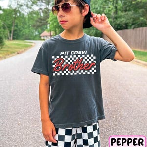 a young boy wearing a hat and sunglasses