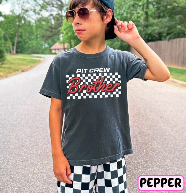 a young boy wearing a hat and sunglasses
