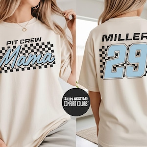 A woman wearing a white t-shirt with a checkered pattern and text, and the number 29 on the back.