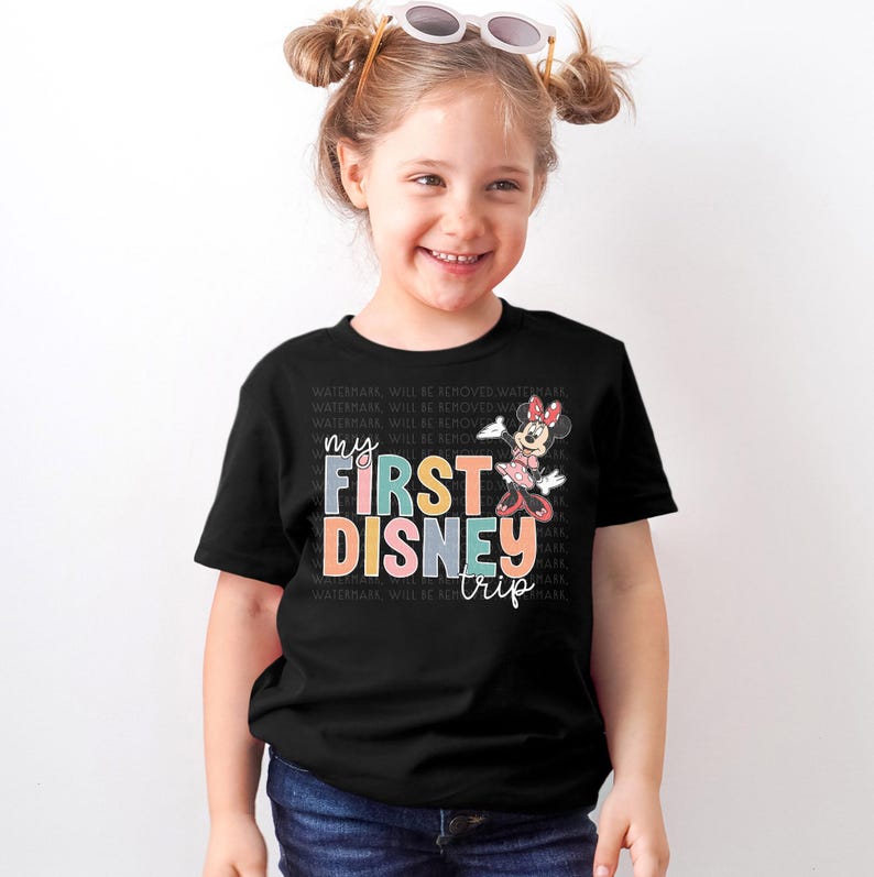 a little girl wearing a mickey mouse shirt
