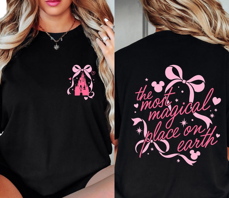 a woman wearing a black t-shirt with a pink design and text on the back.