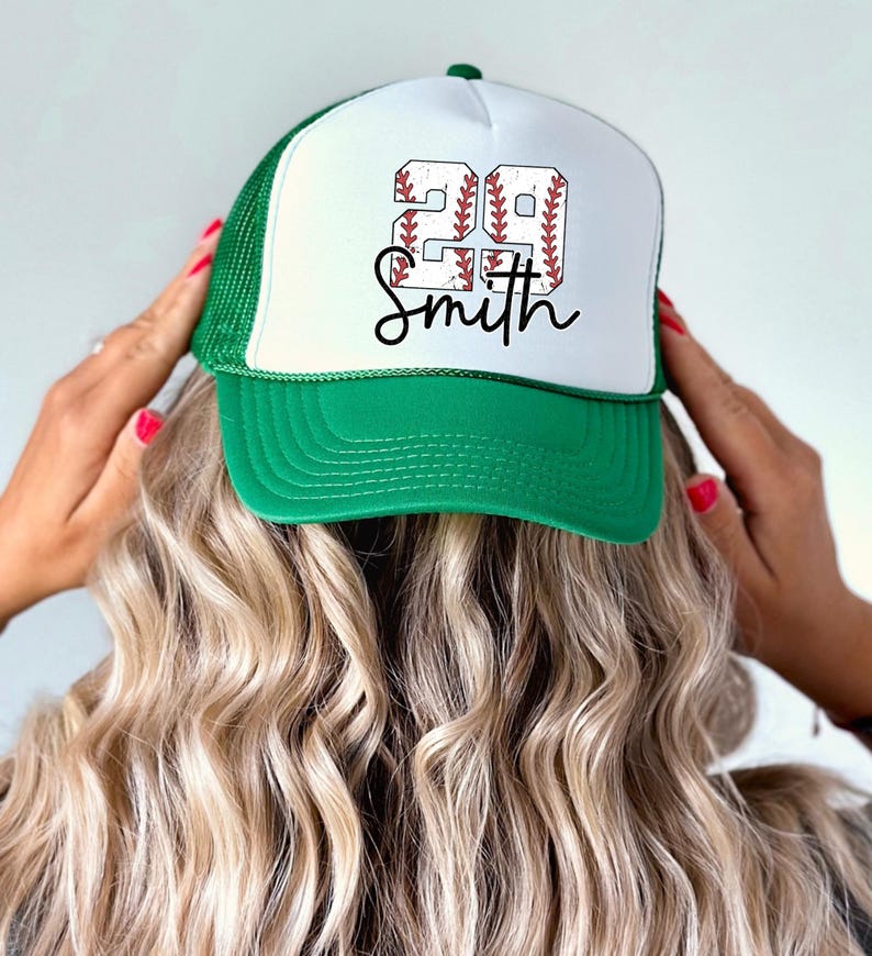 a woman putting on a baseball hat with the word go smith on it