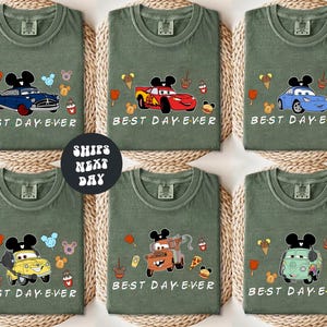 six green t-shirts with various cartoon car designs and the text "BEST DAY EVER" printed on them.
