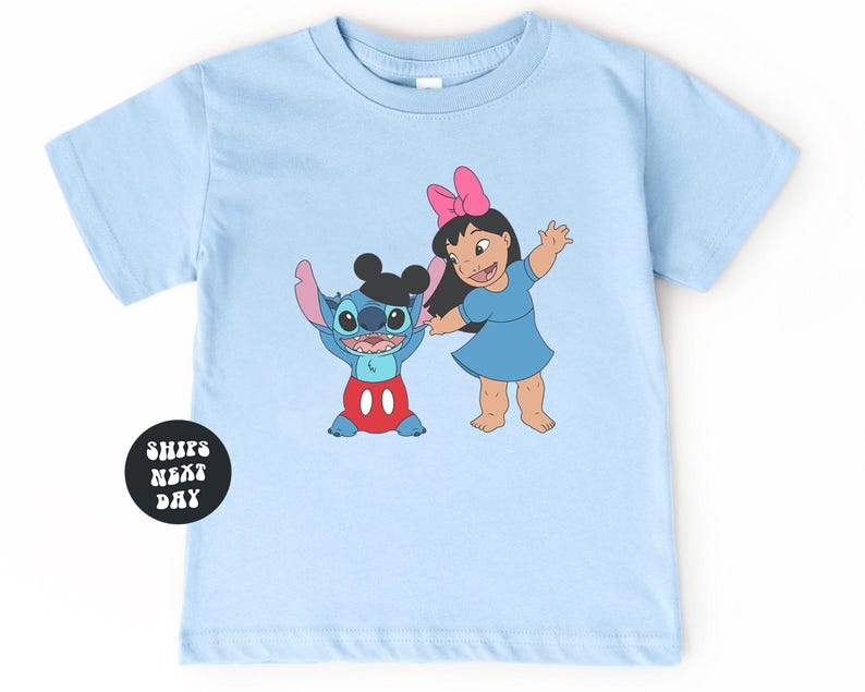 A light blue t-shirt with a cartoon image of two characters, Stitch and Lilo, standing next to each other.