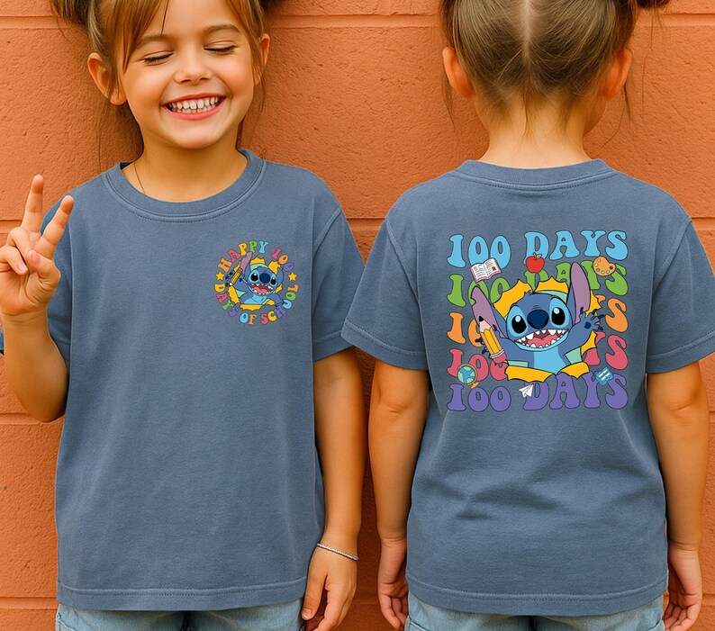A young girl wearing a blue t-shirt with a cartoon character and text printed on it.