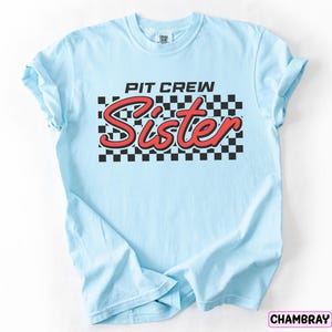 a blue shirt that says pit crew sister