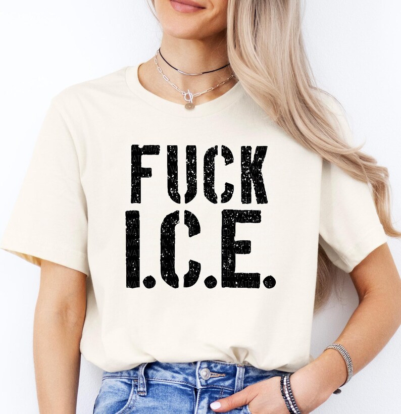 a woman wearing a white t - shirt that says fuck ice