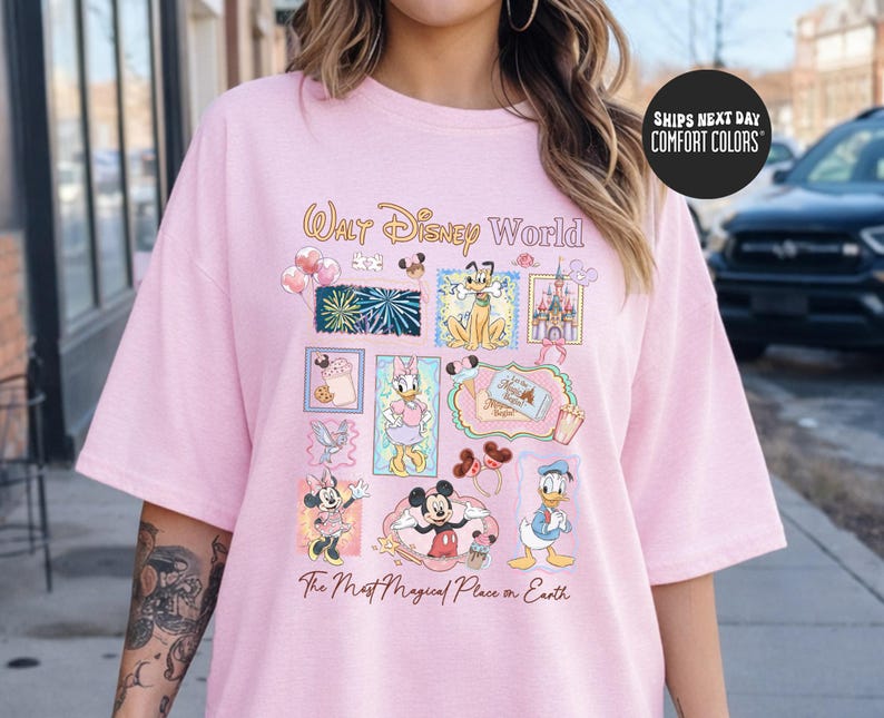 A woman wearing a pink t-shirt with Disney World graphics and text.