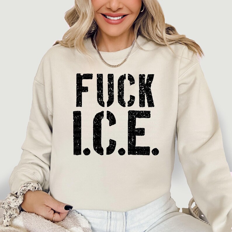 a woman wearing a sweatshirt that says fuck ice