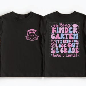 A black t-shirt with a pink graduation cap and the text "so long, Kinder Garten, it's been fun, look out 1st Grade here I come!" printed on it.