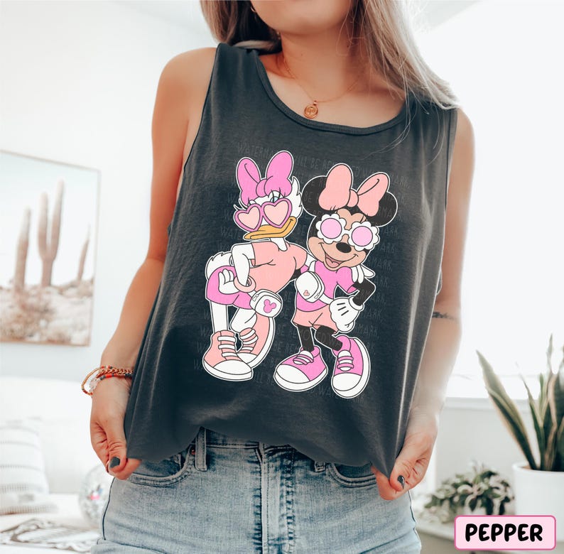 a woman wearing a tank top with a cartoon character on it