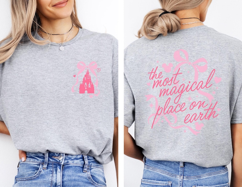 a woman wearing a gray t-shirt with a pink castle graphic and text on the back.