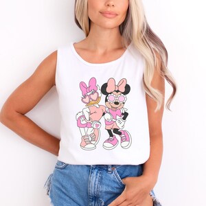 a woman wearing a mickey and minnie mouse shirt