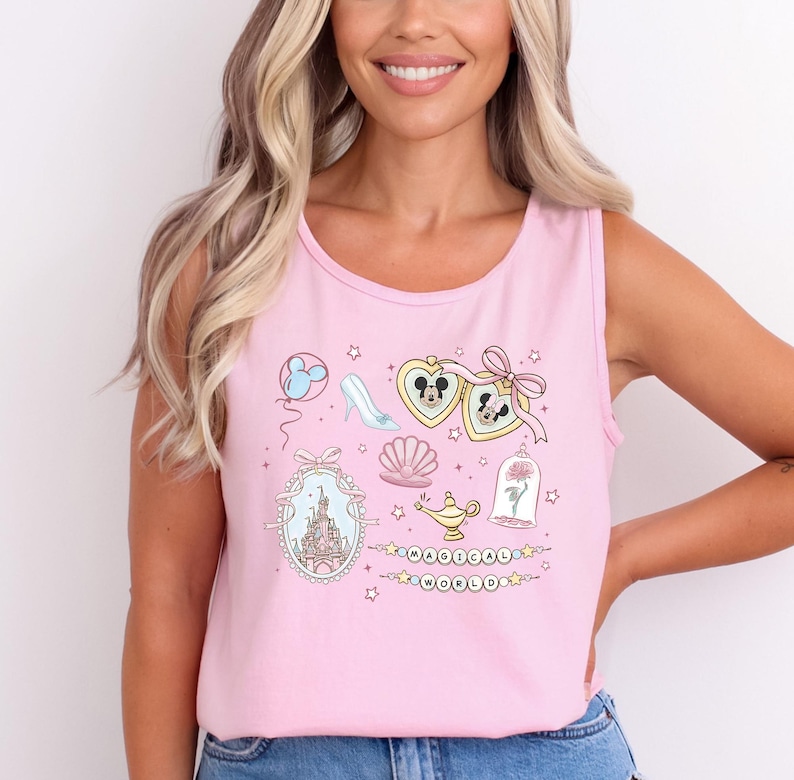 A woman with long blonde hair is smiling and wearing a pink tank top with various Disney-themed illustrations and text.