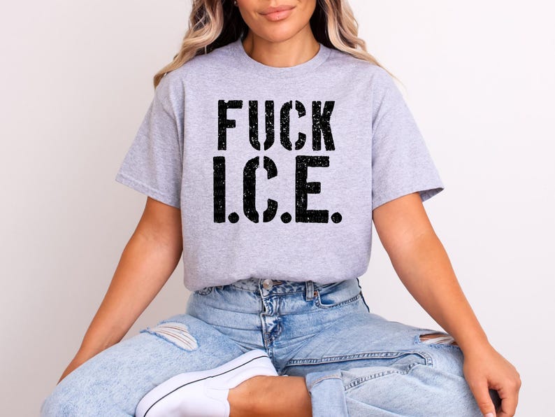 a woman sitting on a chair wearing a t - shirt that says fuck ice