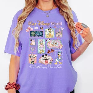 A woman wearing a purple t-shirt with Disney characters and text, including Mickey Mouse, Minnie Mouse, Donald Duck, and other Disney characters.
