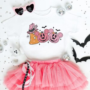 a white shirt with pink tutu and a pink tutu skirt