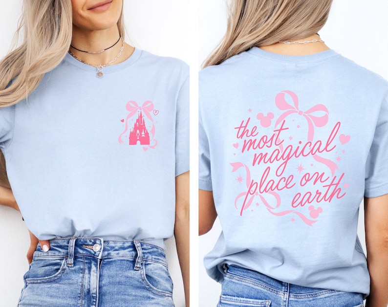 A woman wearing a light blue t-shirt with a pink castle graphic and the text "the most magical place on earth" printed on the back.