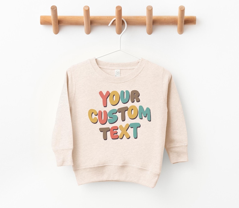 a sweater hanging on a wooden hanger