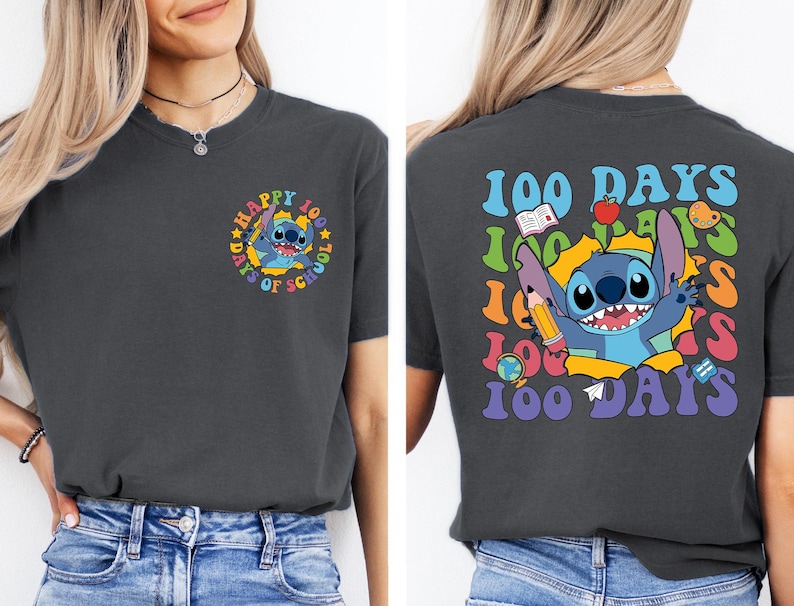 a woman wearing a black t-shirt with a colorful graphic design on the back. The design includes a cartoon character and text related to the 100 Days of School.