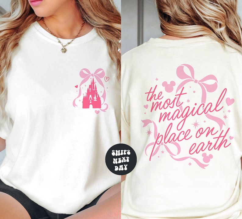 A woman wearing a white t-shirt with a pink castle and hearts printed on it. The t-shirt has text on the back that says "the most magical place on earth".