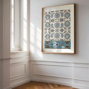 May include: A framed print of a traditional Turkish tile design with blue, white and black floral patterns on a cream background.