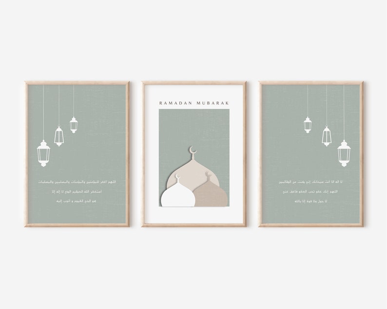 May include: Three printable wall art prints with a sage green background. The center print features a mosque with a white dome and a brown dome. The text "RAMADAN MUBARAK" is at the top of the print. The left and right prints feature white lanterns hanging from the ceiling. Arabic text is on each print.